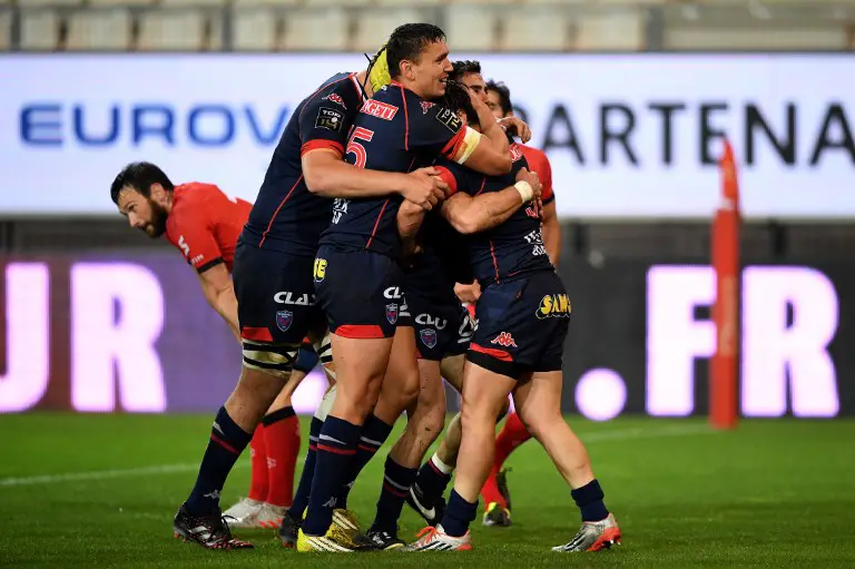 Grenoble's French scrumhalf Lilian Saseras is congratulated by his teammate after scoring a try during the French Top 14 rugby union match between Grenoble (FCG) and Lyon (LOU) on May 6, 2017 at the Stade des Alpes in Grenoble. / AFP PHOTO / JEAN-PIERRE CLATOT