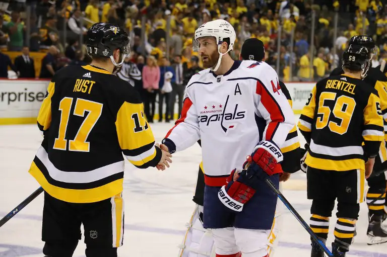 PITTSBURGH, PA - MAY 07: Brooks Orpik #44 of the Washington Capitals shakes hands with Bryan Rust #17 of the Pittsburgh Penguins after a 4-2 series win after Game Six of the Eastern Conference Second Round during the 2018 NHL Stanley Cup Playoffs at PPG Paints Arena on May 7, 2018 in Pittsburgh, Pennsylvania.   Gregory Shamus/Getty Images/AFP