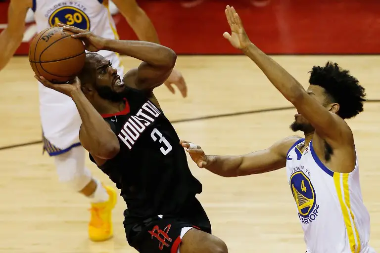 HOUSTON, TX - MAY 24: Chris Paul #3 of the Houston Rockets goes up against Quinn Cook #4 of the Golden State Warriors in the fourth quarter of Game Five of the Western Conference Finals of the 2018 NBA Playoffs at Toyota Center on May 24, 2018 in Houston, Texas.   Bob Levey/Getty Images/AFP