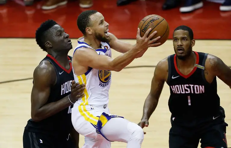 HOUSTON, TX - MAY 28: Stephen Curry #30 of the Golden State Warriors goes up against Clint Capela #15 and Trevor Ariza #1 of the Houston Rockets in the second quarter of Game Seven of the Western Conference Finals of the 2018 NBA Playoffs at Toyota Center on May 28, 2018 in Houston, Texas. NOTE TO USER: User expressly acknowledges and agrees that, by downloading and or using this photograph, User is consenting to the terms and conditions of the Getty Images License Agreement.   Bob Levey/Getty Images/AFP