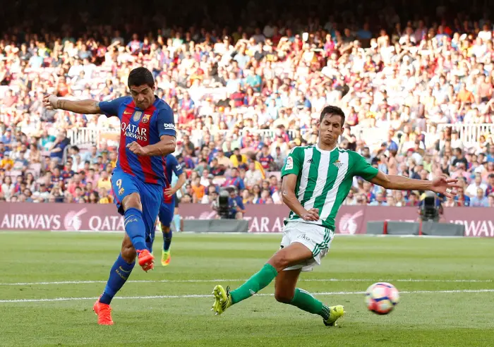 Barcelona's Luis Suarez scores a goal past Real Betis' Aissa Mandi.