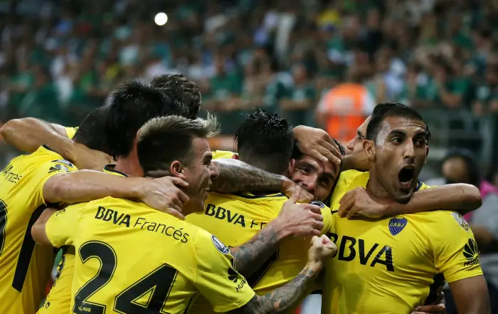 Soccer Football - Palmeiras v Boca Juniors - Copa Libertadores - Allianz Parque Stadium, Sao Paulo, Brazil - April 11, 2018. Carlos Tevez (2nd R) of Argentina's Boca Juniors is embraced by teammates after scoring a goal.