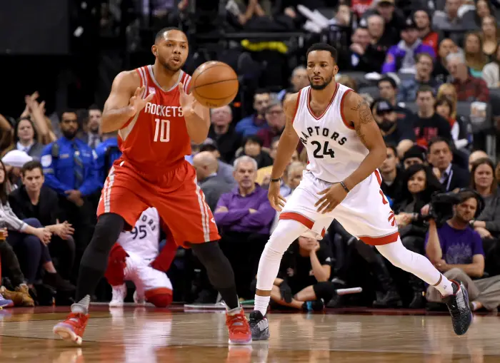 Jan 8, 2017; Toronto, Ontario, CAN; Houston Rockets guard Eric Gordon (10) takes a pass beside Toronto Raptors guard Norman Powell (24) during the second half at Air Canada Centre.