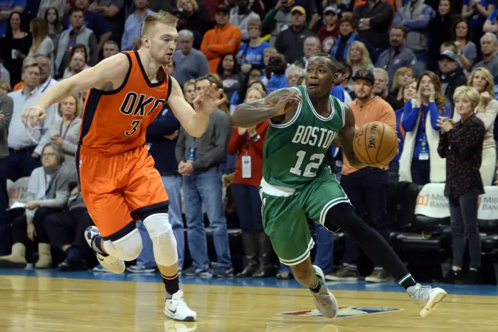 Boston Celtics guard Terry Rozier (12) drives to the basket in front of Oklahoma City Thunder forward Domantas Sabonis (3)
