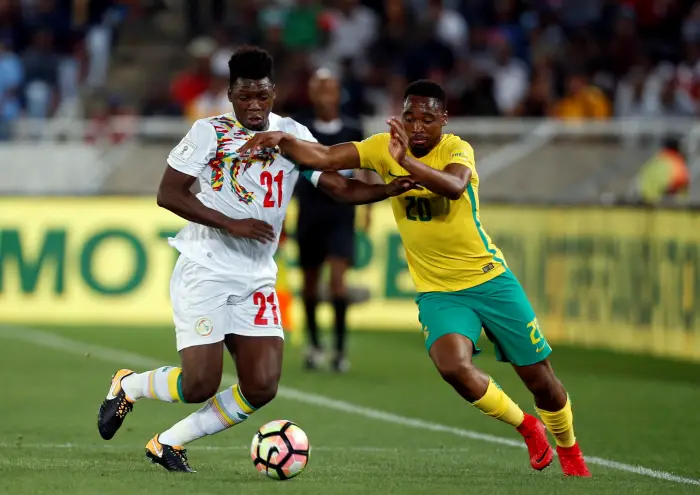 Senegal's Lamine Gassama in action with South Africa's Sibusiso Vilakazi