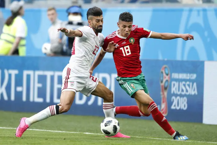 Saint Petersburg, 15-06-2018 , World Cup 2018 , Saint Petersburg Stadium. Morocco midfielder Amine Harit (R) and Iran defender Ramin Rezaeian (L) during the match Morocco - Iran