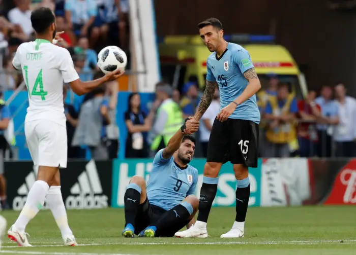 Soccer Football - World Cup - Group A - Uruguay vs Saudi Arabia - Rostov Arena, Rostov-on-Don, Russia - June 20, 2018   Uruguay's Matias Vecino helps up team mate Luis Suarez