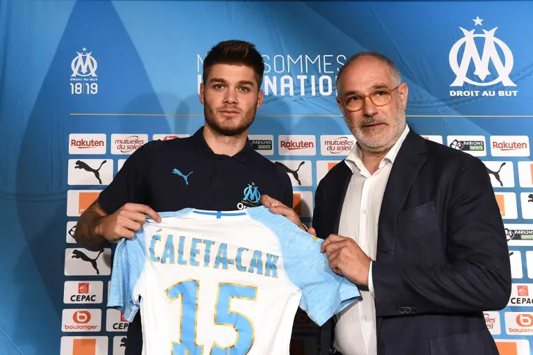 Marseille's newly recruited Croatian defender Duje Caleta-Car holds his new jersey with Olympique de Marseille's sportive manager Andoni Zubizarreta (R) during his official presentation at the Robert-Louis Dreyfus training centre in Marseille, southern France, on July 20, 2018.    / AFP PHOTO / Boris HORVAT