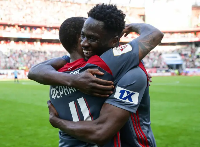 Lokomotiv Moscow's Eder (R) and Manuel Fernandes hug after winning the 2017/18 Russian Premier Football League Round 29 football match against Zenit St Petersburg at RZD Arena Stadium; the victory over Zenit St Petersburg also became Lokomotiv Moscow's victory in the 2017/18 Russian Premier Football League