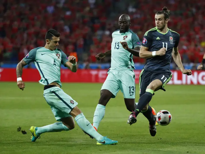 Portugal's Jose Fonte and Danilo in action with Wales' Gareth Bale
