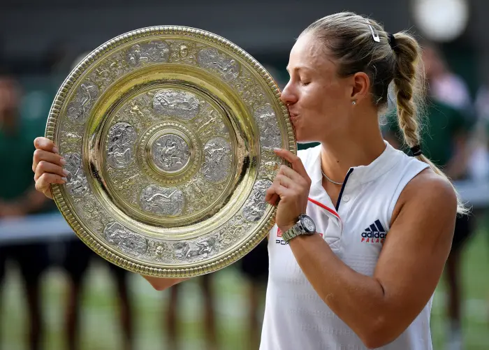Tennis - Wimbledon - All England Lawn Tennis and Croquet Club, London, Britain - July 14, 2018  Germany's Angelique Kerber holds the trophy after winning the women's singles final against Serena Williams of the U.S.