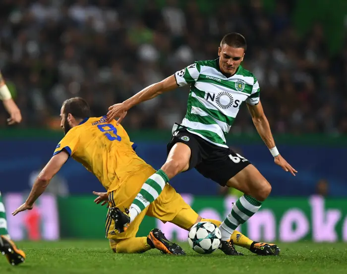 LISBON, Nov. 1, 2017 Gonzalo Higuain of Juventus (L) vies with Joao Palhinha of Sporting during their UEFA Champions League group D match in Lisbon, Portugal on Oct. 31, 2017. The match ended with a 1-1 draw.