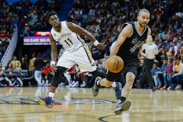 Jan 27, 2017; New Orleans, LA, USA; San Antonio Spurs guard Tony Parker (9) drives past New Orleans Pelicans guard Jrue Holiday (11) during the second half of a game at the Smoothie King Center. The Pelicans defeated the Spurs 119-103.