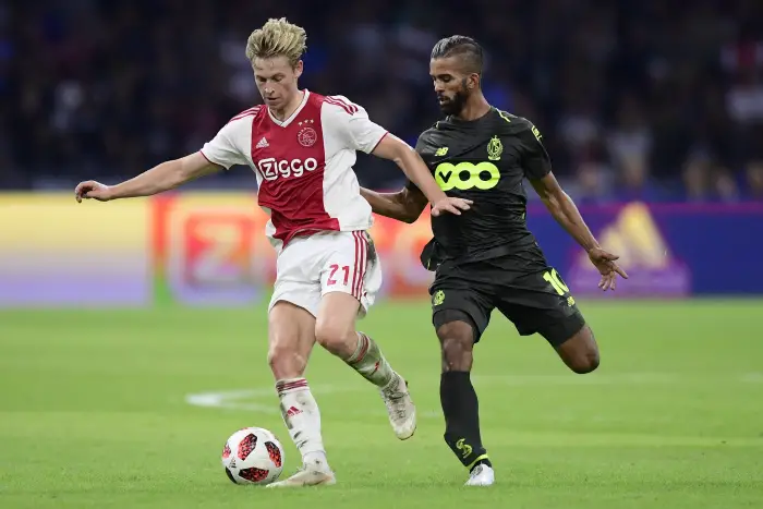 AMSTERDAM, THE NETHERLANDS - AUGUST 14 : Frenkie de Jong midfielder of Ajax is challenged by Medhi Carcela midfielder of Standard Liege during the UEFA Champions League Third qualifying round , 2nd leg match between  Ajax and Standard Liege at the Johan Cruijff ArenA stadium on August 14, 2018 in Amsterdam, The Netherlands, 14/08/2018