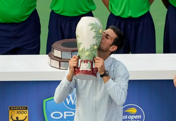 CINCINNATI, OH - AUGUST 19: Novak Djokovic of Serbia kisses the trophy after defeating Roger Federer of Switzerland (not pictured) in the Western & Southern Open singles final at the Lindner Family Tennis Center in Mason, Ohio on August 19, 2018.
