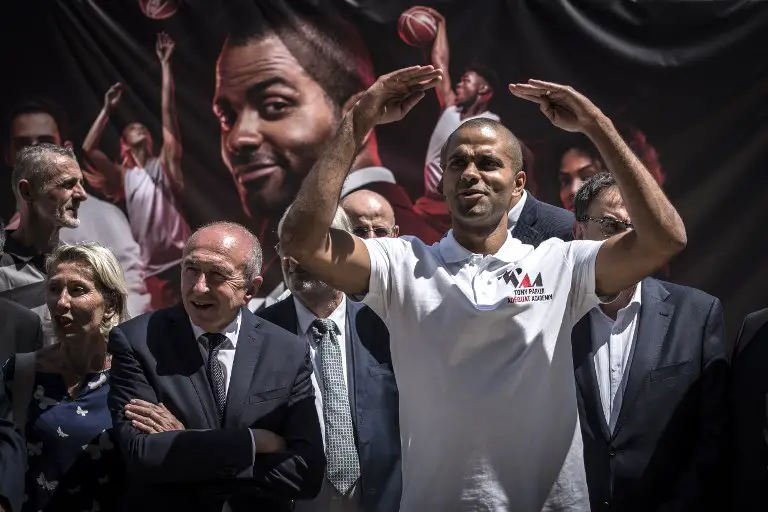 French basketball player Tony Parker (R) and French Interior Minister Gerard Collomb (L) attend the the laying of the first stone of Tony Parker Adequat Academy on June 29, 2018, in Lyon. / AFP PHOTO / JEAN-PHILIPPE KSIAZEK