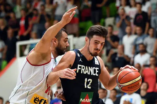France's Nando De Colo (R) fights for the ball with Bulgaria's Pavel Marinov (L) during the 2019 FIBA European qualifying basketball match between Bulgaria and France at The Botevgrad Arena in Botevgrad on September 13, 2018. / AFP PHOTO / Dimitar DILKOFF