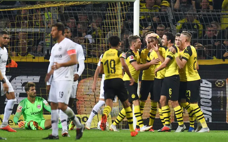 Dortmund's French defender Abdou Diallo celebrates scoring the opening goal with his teammates during the German first division Bundesliga football match Borussia Dortmund v Eintracht Frankfurt in Dortmund, western Germany, on September 14, 2018. / AFP PHOTO / Patrik STOLLARZ / RESTRICTIONS: DFL REGULATIONS PROHIBIT ANY USE OF PHOTOGRAPHS AS IMAGE SEQUENCES AND/OR QUASI-VIDEO