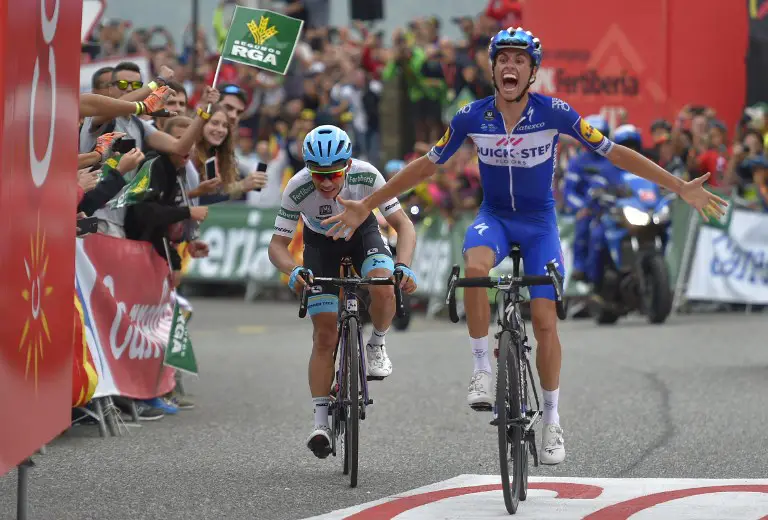 Quick Step Floors' Spanish cyclist Enric Mas (R) celebrates next to Team Astana's Colombian cyclist Miguel Angel Lopez (L) as he wins the 20th stage of the 73rd edition of "La Vuelta" Tour of Spain cycling race, a 97,3 km hilly route from Les Escaldes to Collada de la Gallina in Andorra, on September 15, 2018. / AFP PHOTO / Ander GILLENEA