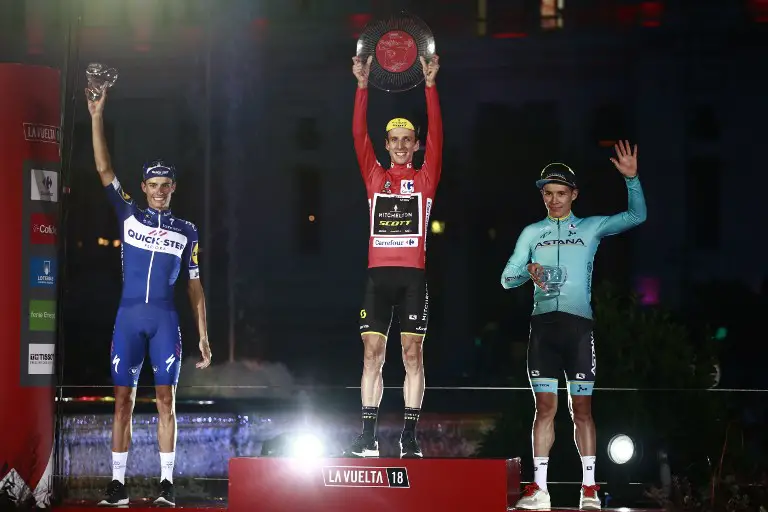 Mitchelton-Scott's British cyclist Simon Philip Yates (C), Quick Step Floors' Spanish cyclist Enric Mas (L) and Team Astana's Colombian cyclist Miguel Angel Lopez (R) celebrate on the podium of the 73rd edition of "La Vuelta" Tour of Spain cycling race in Madrid on September 16, 2018.
Simon Yates stepped out of the shadows of British cycling giants Sky to secure his maiden Grand Tour triumph at the Tour of Spain for his Mitchelton team. / AFP PHOTO / Benjamin CREMEL