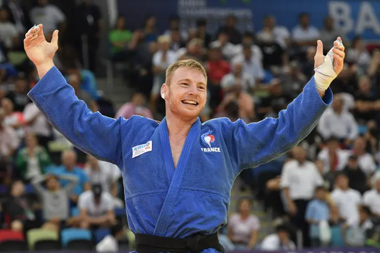 Axel Clerget of France celebrates his victory against Eduard Trippel of Germany in the men's under 90kg category bronze medal bout of the 2018 Judo World Championships in Baku on September 24, 2018. / AFP PHOTO / Mladen ANTONOV