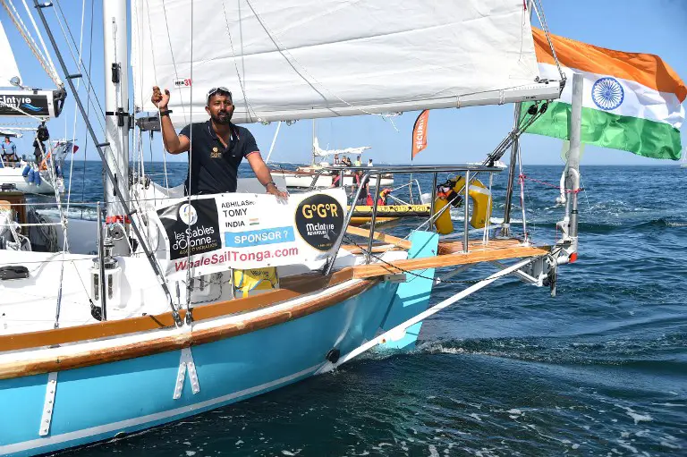 (FILES) In this file photo taken on July 01, 2018 India's Abhilash Tomy gestures on his boat "Thuriya" as he sets off from Les Sables d'Olonne Harbour at the start of the solo around-the-world "Golden Globe Race" ocean race in which sailors compete without high technology aides such as GPS or computers.
A solo Indian sailor adrift thousands of kilometres from dry land with a serious back injury was safely rescued from his stricken yacht on September 24 after an international effort. / AFP PHOTO / JEAN-FRANCOIS MONIER