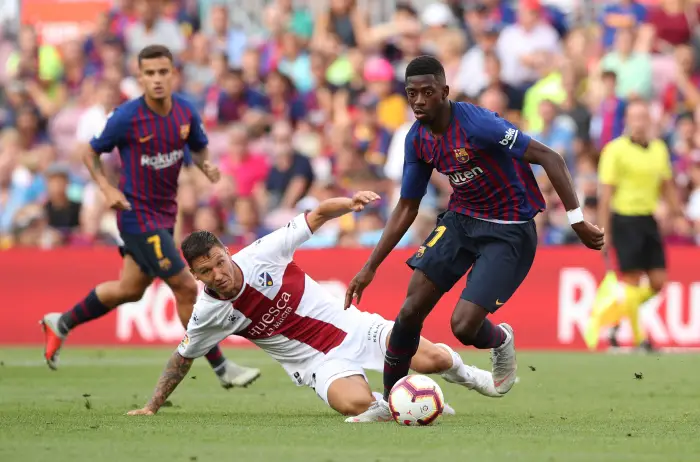Barcelona's Ousmane Dembele in action with Huesca's Damian Musto