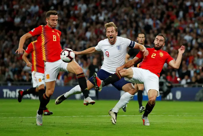 Soccer Football - UEFA Nations League - League A - Group 4 - England v Spain - Wembley Stadium, London, Britain - September 8, 2018  England's Harry Kane goes down during a challenge with Spain's Saul Niguez and Dani Carvajal