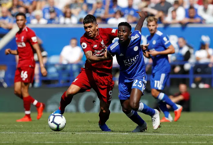 Liverpool's Roberto Firmino in action with Leicester City's Wilfred Ndidi