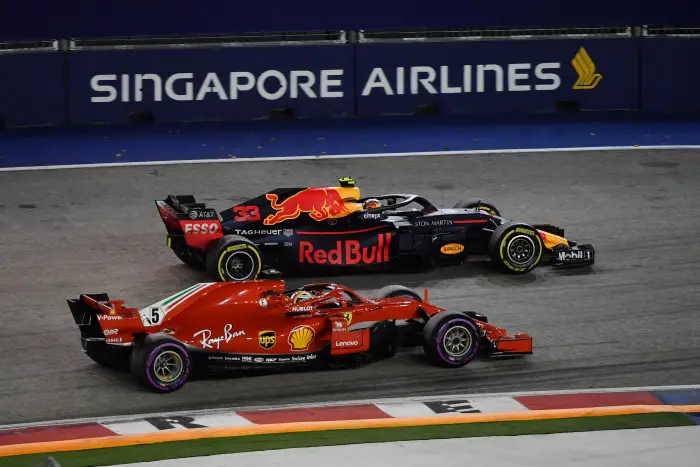 Sebastian Vettel, Ferrari SF71H and Max Verstappen, Red Bull Racing RB14 battle at Formula One World Championship, Rd15, Singapore Grand Prix, Race, Marina Bay Circuit, Singapore, Sunday 16 September 2018.