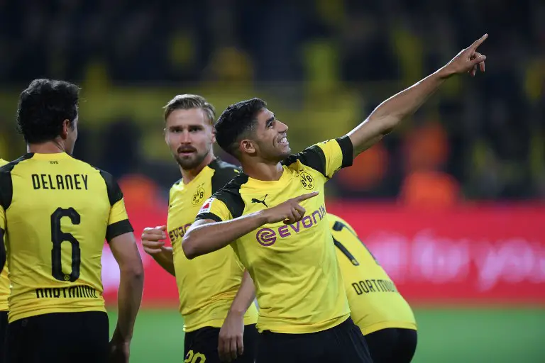 Dortmund's Moroccan defender Achraf Hakimi celebrates scoring his team's third goal during the German first division Bundesliga football match Borussia Dortmund vs 1. FC Nuremberg in Dortmund, westhern Germany, on September 26, 2018. (Photo by Patrik STOLLARZ / AFP) / RESTRICTIONS: DFL REGULATIONS PROHIBIT ANY USE OF PHOTOGRAPHS AS IMAGE SEQUENCES AND/OR QUASI-VIDEO