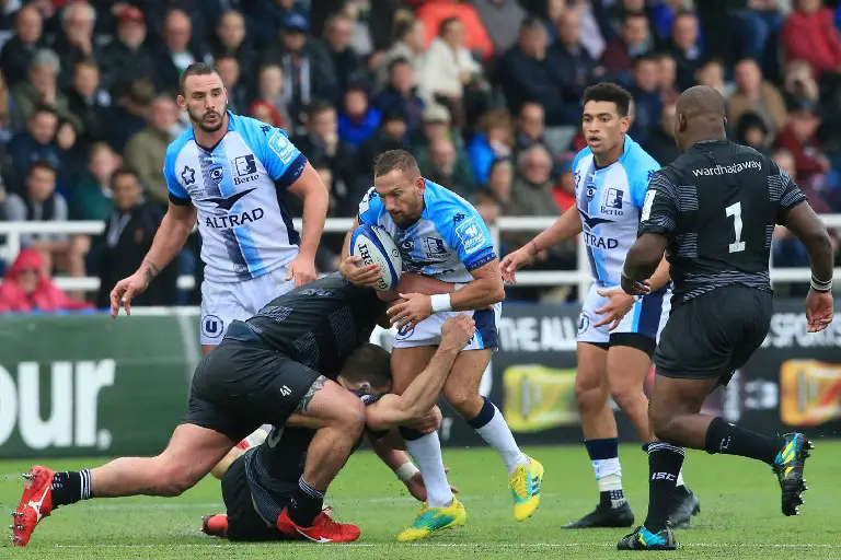 Montpellier's New Zealand fly-half Aaron Cruden is tackled during the European Rugby Champions Cup pool 5, rugby union match between Newcastle Falcons and Montpellier at Kingston Park in Newcastle-upon-Tyne, north east England on October 21, 2018. (Photo by Lindsey PARNABY / AFP)