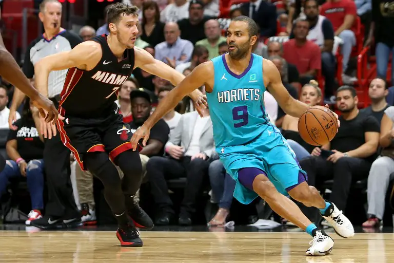 MIAMI, FL - OCTOBER 20: Tony Parker #9 of the Charlotte Hornets dribbles with the ball against Goran Dragic #7 of the Miami Heat during the second half at American Airlines Arena on October 20, 2018 in Miami, Florida. NOTE TO USER: User expressly acknowledges and agrees that, by downloading and or using this photograph, User is consenting to the terms and conditions of the Getty Images License Agreement.   Michael Reaves/Getty Images/AFP