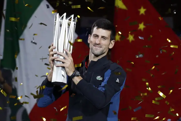 Novak Djokovic of Serbia celebrates with the trophy after winning the final