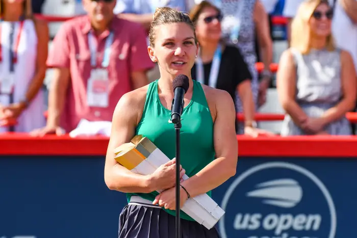 MONTREAL, QC - AUGUST 12: Simona Halep (ROU) speaks to the crowd and holds her trophy after winning the WTA Coupe Rogers 2018 final on August 12, 2018 at IGA Stadium in Montr©al, QC