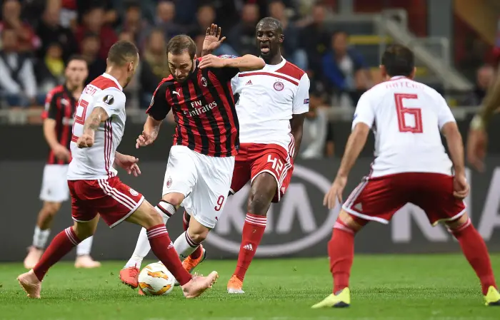 AC Milan's Gonzalo Higuain in action with Olympiacos' Yaya Toure
