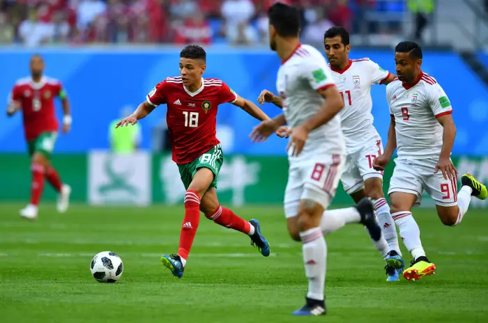 Soccer Football - World Cup - Group B - Morocco vs Iran - Saint Petersburg Stadium, Saint Petersburg, Russia - June 15, 2018   Morocco's Amine Harit in action with Iran's Omid Ebrahimi and Vahid Amiri