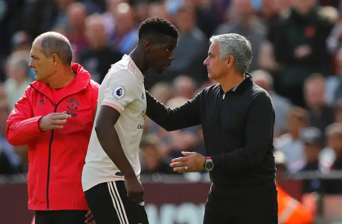 Manchester United's Paul Pogba with manager Jose Mourinho after being substituted off