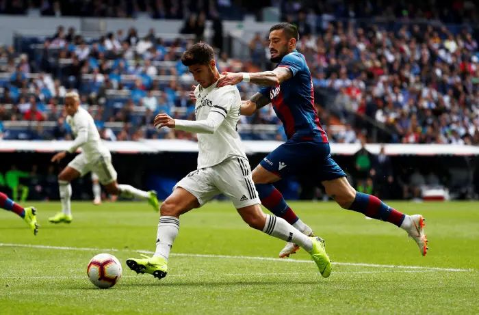 Real Madrid's Marco Asensio in action with Levante's Erick Cabaco