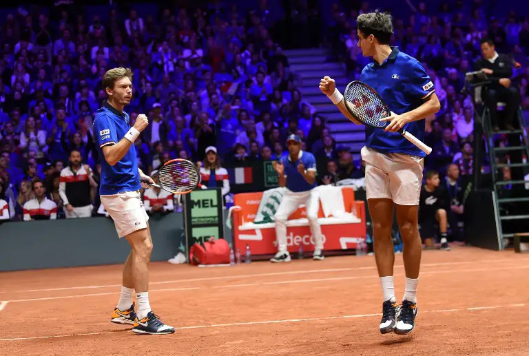 France's Nicolas Mahut (L) and  France's Pierre-Hugues Herbert react as they compete against Croatia's Mate Pavic and Croatia's Ivan Dodig during their doubles rubber for the Davis Cup final tennis match between France and Croatia at The Pierre Mauroy Stadium in Villeneuve-d'Ascq, northern France, on November 24, 2018. (Photo by Philippe HUGUEN / AFP)