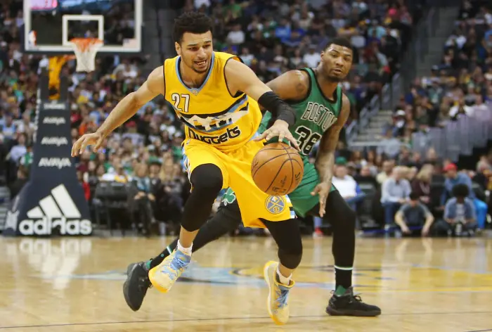 March 10, 2017; Denver, CO, USA; Denver Nuggets guard Jamal Murray (27) moves the ball controls the ball against Boston Celtics guard Marcus Smart (36) during the second half at Pepsi Center. The Nuggets won 119-99.