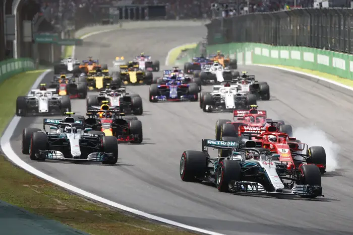 Lewis Hamilton, Mercedes-AMG F1 W09 EQ Power+ leads Valtteri Bottas, Mercedes-AMG F1 W09 EQ Power+ and Sebastian Vettel, Ferrari SF71H who locks up at the start of the race at Formula One World Championship, Rd20, Brazilian Grand Prix, Race, Interlagos, Sao Paulo, Brazil, Sunday 11 November 2018.