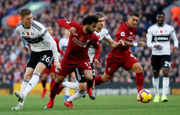 Soccer Football - Premier League - Liverpool v Fulham - Anfield, Liverpool, Britain - November 11, 2018  Liverpool's Mohamed Salah in action with Fulham's Alfie Mawson