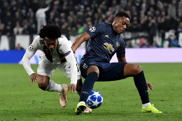 Juan Cuadrado of Juventus and Anthony Martial of Manchester compete for the ball during the Uefa Champions League 2018/2019 Group H football match between Juventus and Manchester United at Juventus stadium, Turin, November, 07, 2018