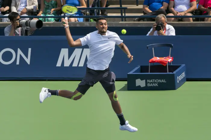TORONTO, ON - AUGUST 07: Nick Kyrgios of Australia leaps to return the ball in his match vs. Stan Wawrinka of Switzerland at the Rogers Cup Tuesday August 7, 2018 at Aviva Centre in Toronto, Ontario Canada. Wawrinka defeated Kyrgios 1-6, 7-5, 7-5