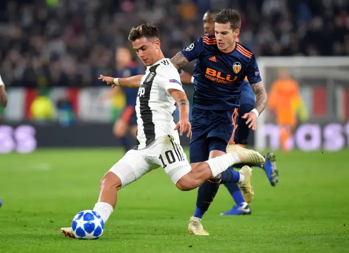 Juventus' Paulo Dybala in action with Valencia's Santi Mina