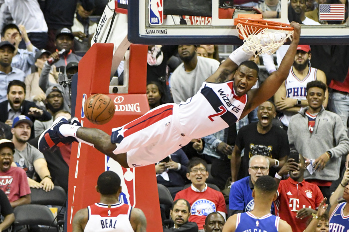 Washington Wizards guard John Wall (2) scores on a dunk in the second half against the Philadelphia 76ers on October 18, 2017 at the Capital One Arena in Washington, D.C.  The Washington Wizards defeated the Philadelphia 76ers 120-115.