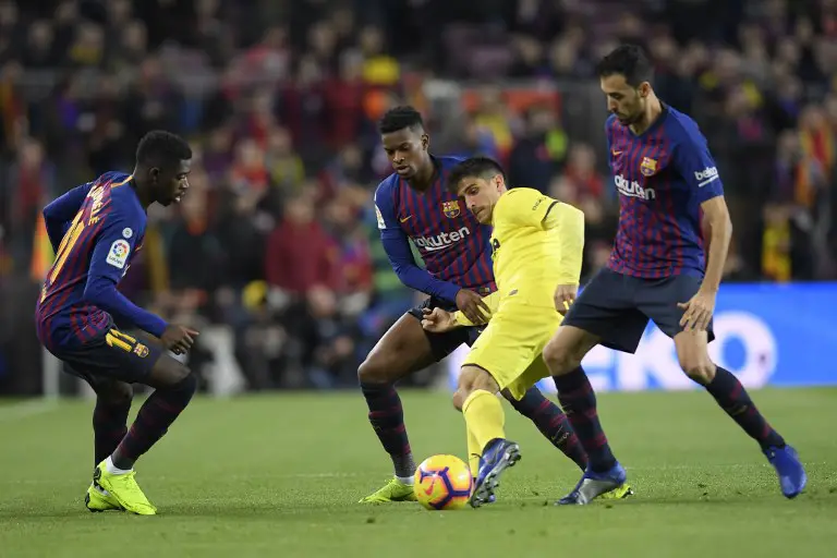 Barcelona's French forward Ousmane Dembele (L), Barcelona's Portuguese defender Nelson Semedo (2L) and Barcelona's Spanish midfielder Sergio Busquets (R) vie for the ball with Villarreal's Spanish forward Gerard Moreno during the Spanish league football match FC Barcelona against Villarreal CF at the Camp Nou stadium in Barcelona on December 2, 2018. (Photo by LLUIS GENE / AFP)