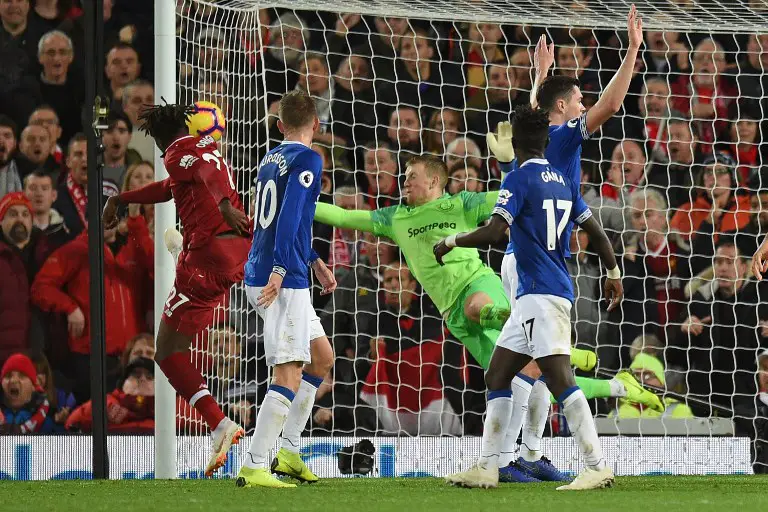 Liverpool's Belgian striker Divock Origi (L) hits the woodward with this late attempt during the English Premier League football match between Liverpool and Everton at Anfield in Liverpool, north west England on December 2, 2018. (Photo by Oli SCARFF / AFP) / RESTRICTED TO EDITORIAL USE. No use with unauthorized audio, video, data, fixture lists, club/league logos or 'live' services. Online in-match use limited to 120 images. An additional 40 images may be used in extra time. No video emulation. Social media in-match use limited to 120 images. An additional 40 images may be used in extra time. No use in betting publications, games or single club/league/player publications. /