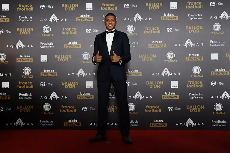 Paris Saint-Germain's French forward Kylian Mbappe poses upon arrival at the 2018 FIFA Ballon d'Or award ceremony at the Grand Palais in Paris on December 3, 2018. - The winner of the 2018 Ballon d'Or will be revealed at a glittering ceremony in Paris on December 3 evening, with Croatia's Luka Modric and a host of French World Cup winners all hoping to finally end the 10-year duopoly of Cristiano Ronaldo and Lionel Messi. (Photo by Anne-Christine POUJOULAT / AFP)